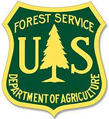 U.S. Forest Service logo, green and yellow badge with tree in the center and U.S. Forest Service, Department of Agriculture text